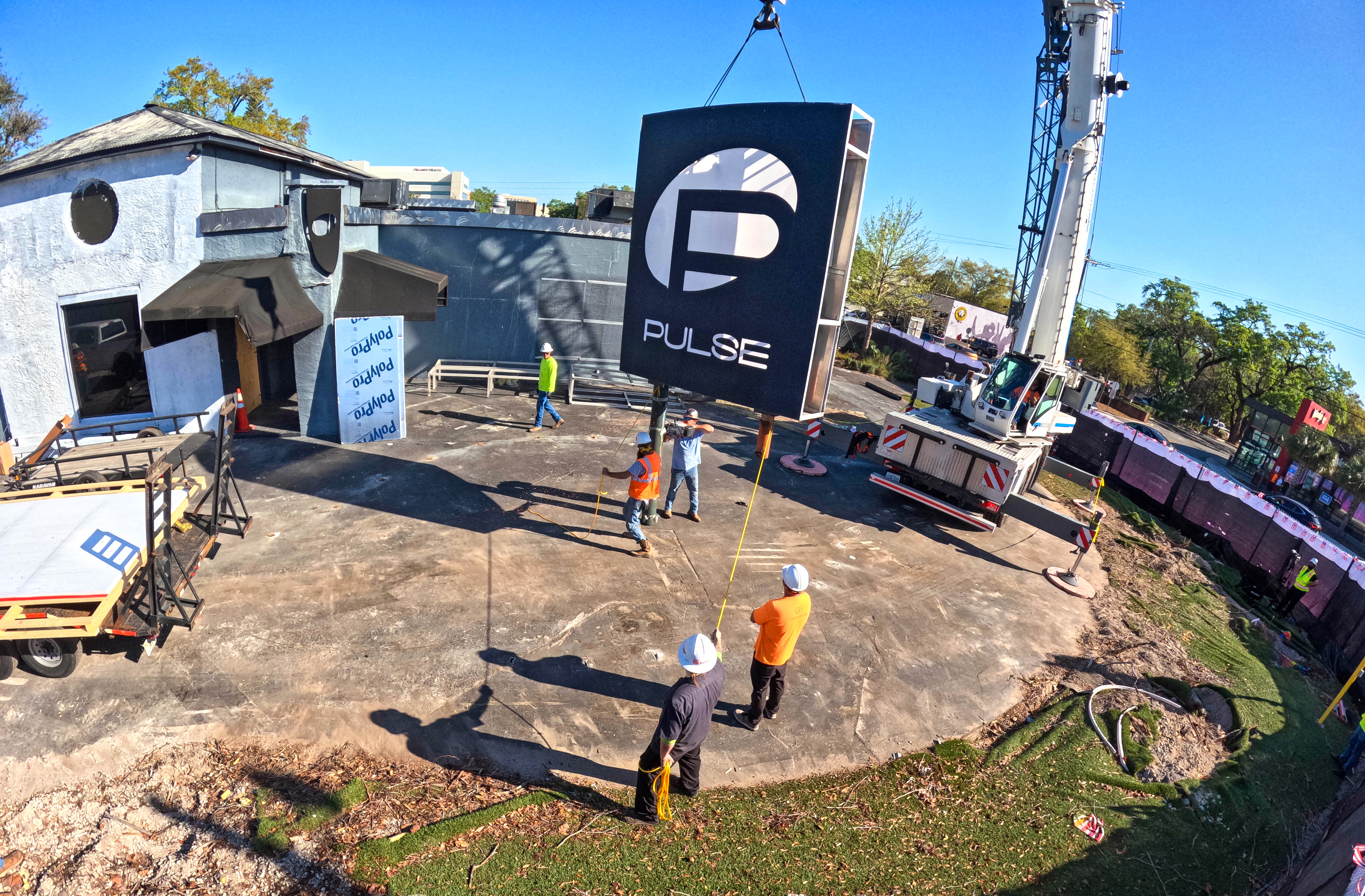 The sign for the Pulse nightclub is removed by workers,...