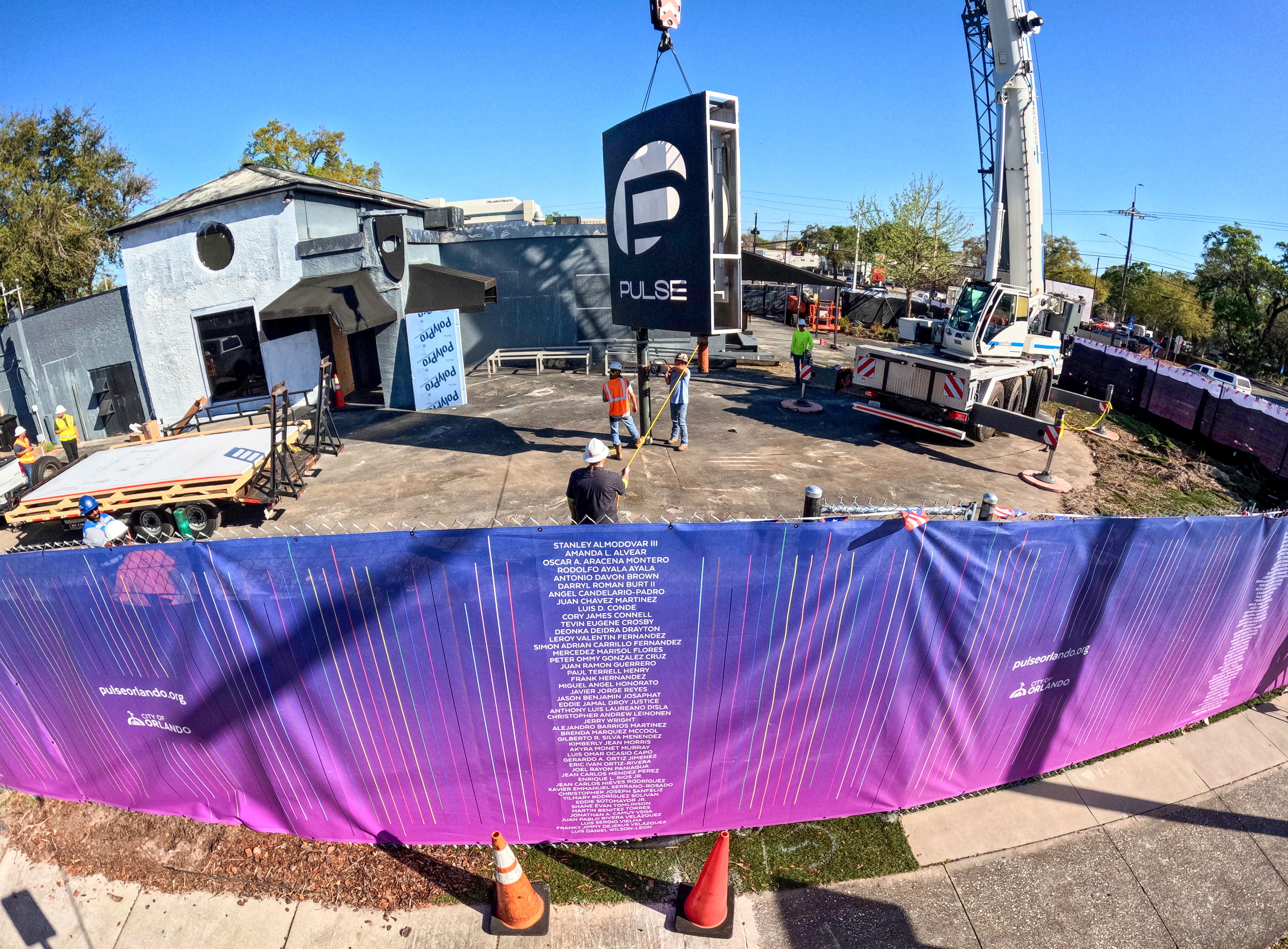 The sign for the Pulse nightclub is removed by workers,...