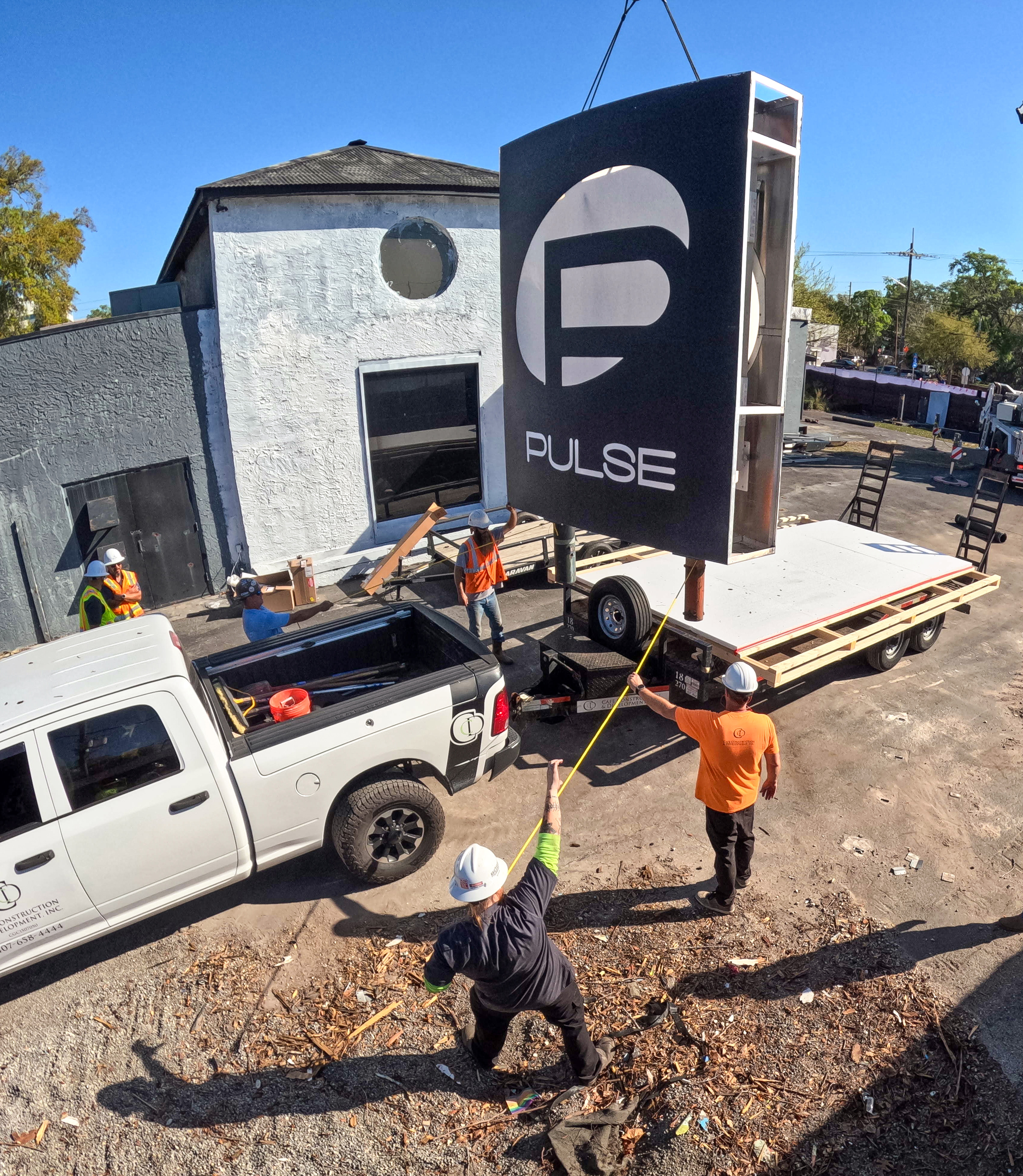 The sign for the Pulse nightclub is removed by workers,...