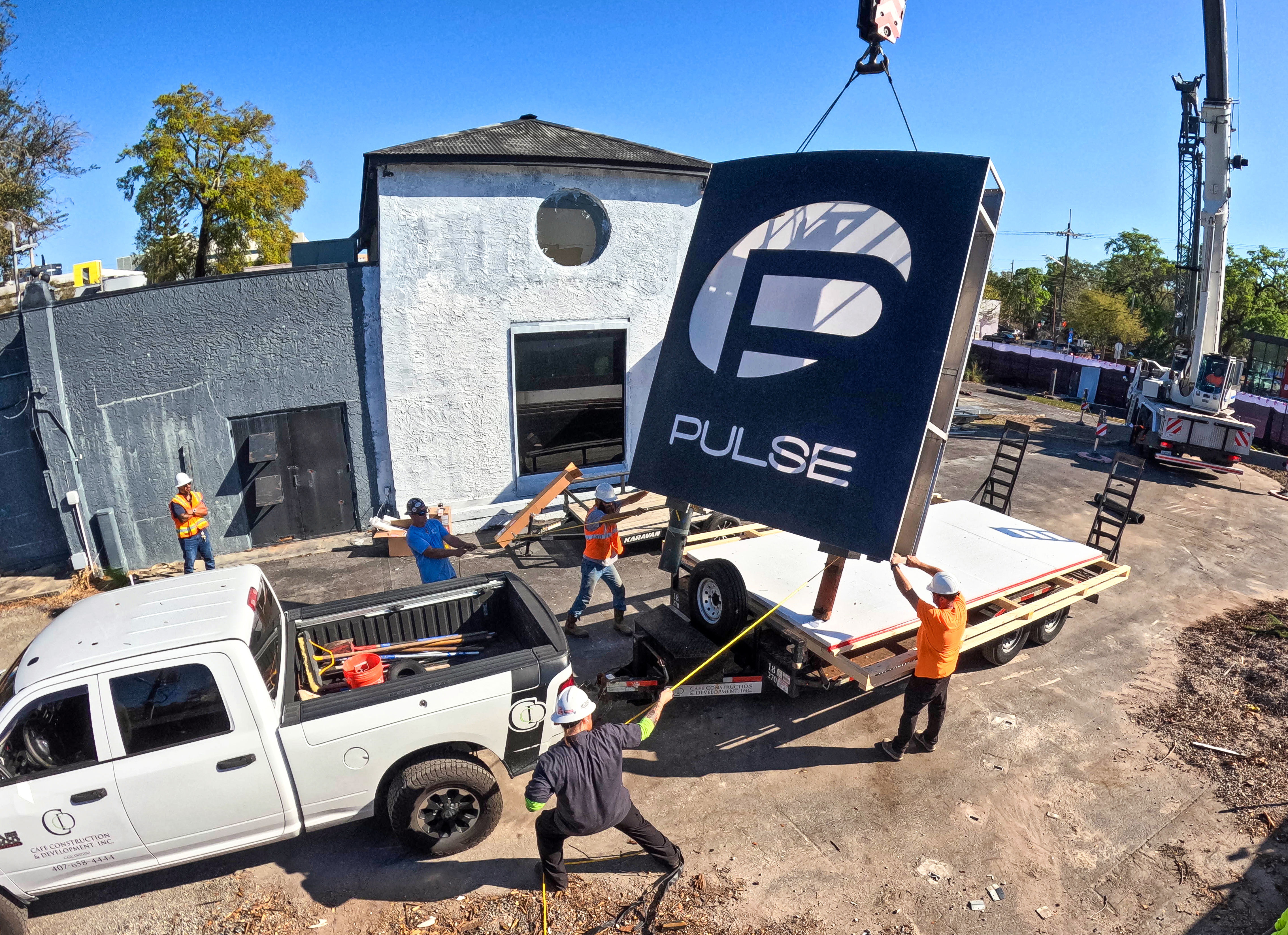 The sign for the Pulse nightclub is removed by workers,...