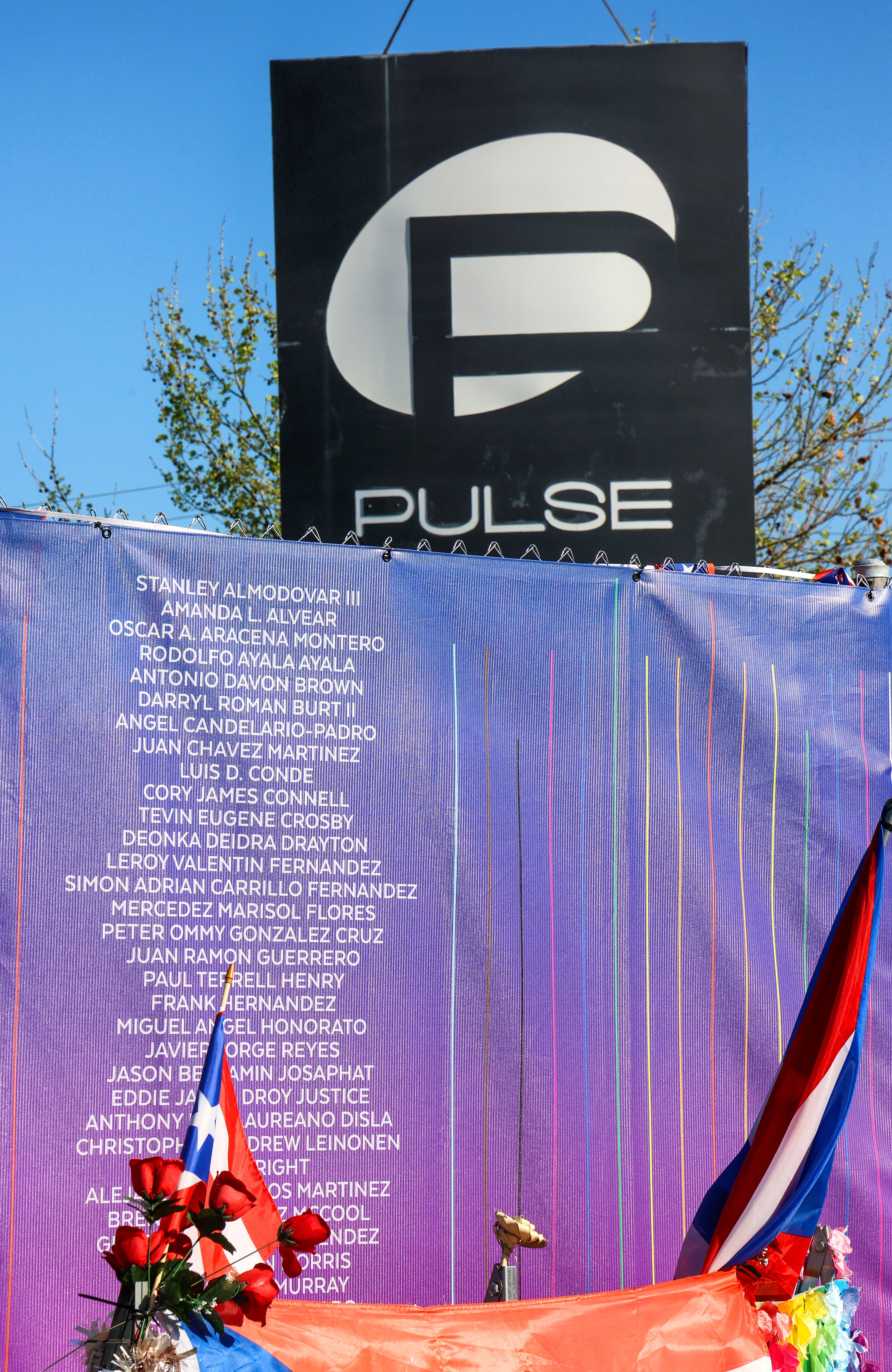 A list of the victims on display while the sign...