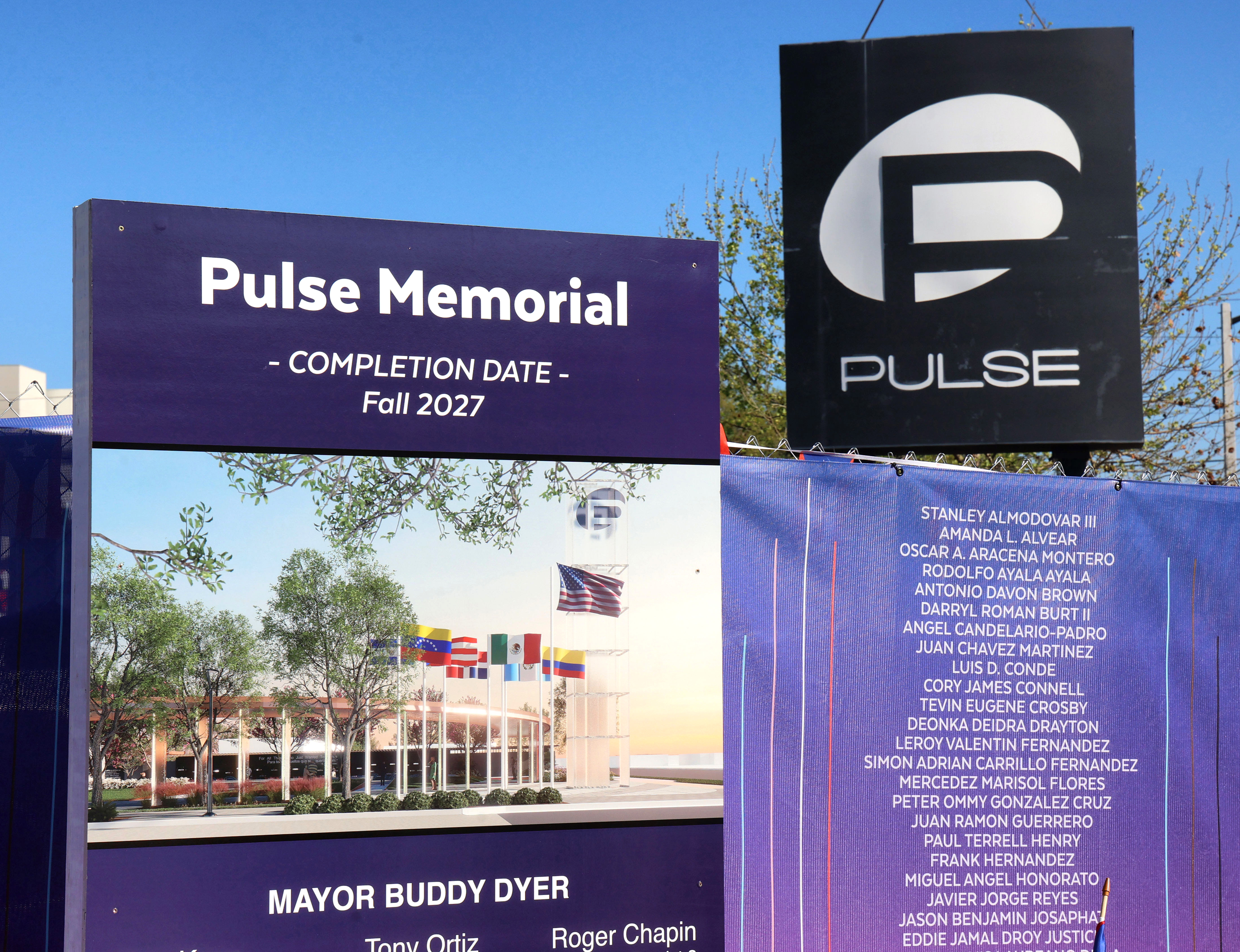 A list of the victims on display while the sign...