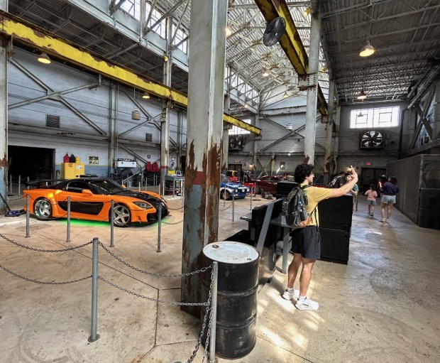 The queue area for Fast & Furious: Supercharged ride at Universal Studios Florida theme park includes winding through an immersive automotive garage setting. (Dewayne Bevil/Orlando Sentinel)