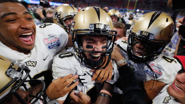 ATLANTA, GA - JANUARY 01: McKenzie Milton #10 of the UCF Knights celebrates with teammates after defeating the Auburn Tigers 34-27 to win the Chick-fil-A Peach Bowl at Mercedes-Benz Stadium on January 1, 2018 in Atlanta, Georgia. (Photo by Kevin C. Cox/Getty Images) ** OUTS - ELSENT, FPG, CM - OUTS * NM, PH, VA if sourced by CT, LA or MoD **
