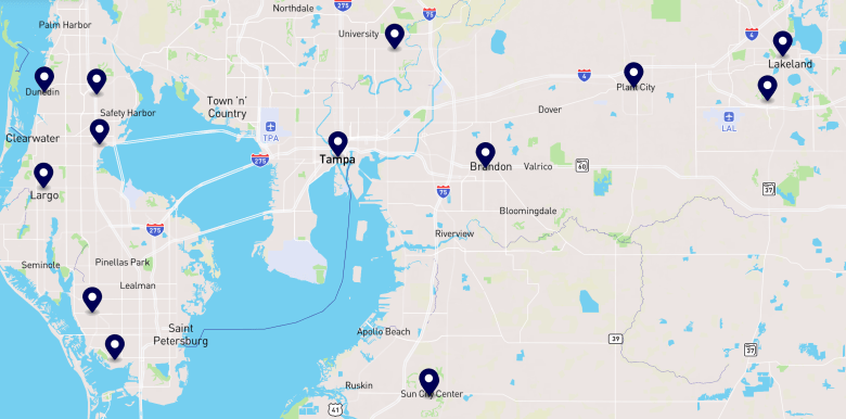 A digital map of the Tampa Bay area featuring approximately 15 dark blue location pins marking 'No Kings' protest sites for March 28, 2026. The pins are spread across Clearwater, Largo, St. Petersburg, Tampa, Brandon, and Riverview. The map shows major geographical features like Old Tampa Bay and Hillsborough Bay, with the pins concentrated near urban centers and major transit corridors.
