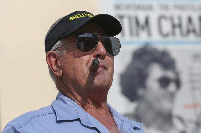 Photographer Tim Chapman welcomes guests to HistoryMiami Museum during the opening of NEWSMAN: the Photojournalism of Tim Chapman on April 15, 2016. Chapman was the inspiration behind the protagonist of Carl Hiaasen’s 1987 book ‘Double Whammy,’ which ABC adapted into a TV show that began airing in 2026. The show is also streaming on Hulu.  