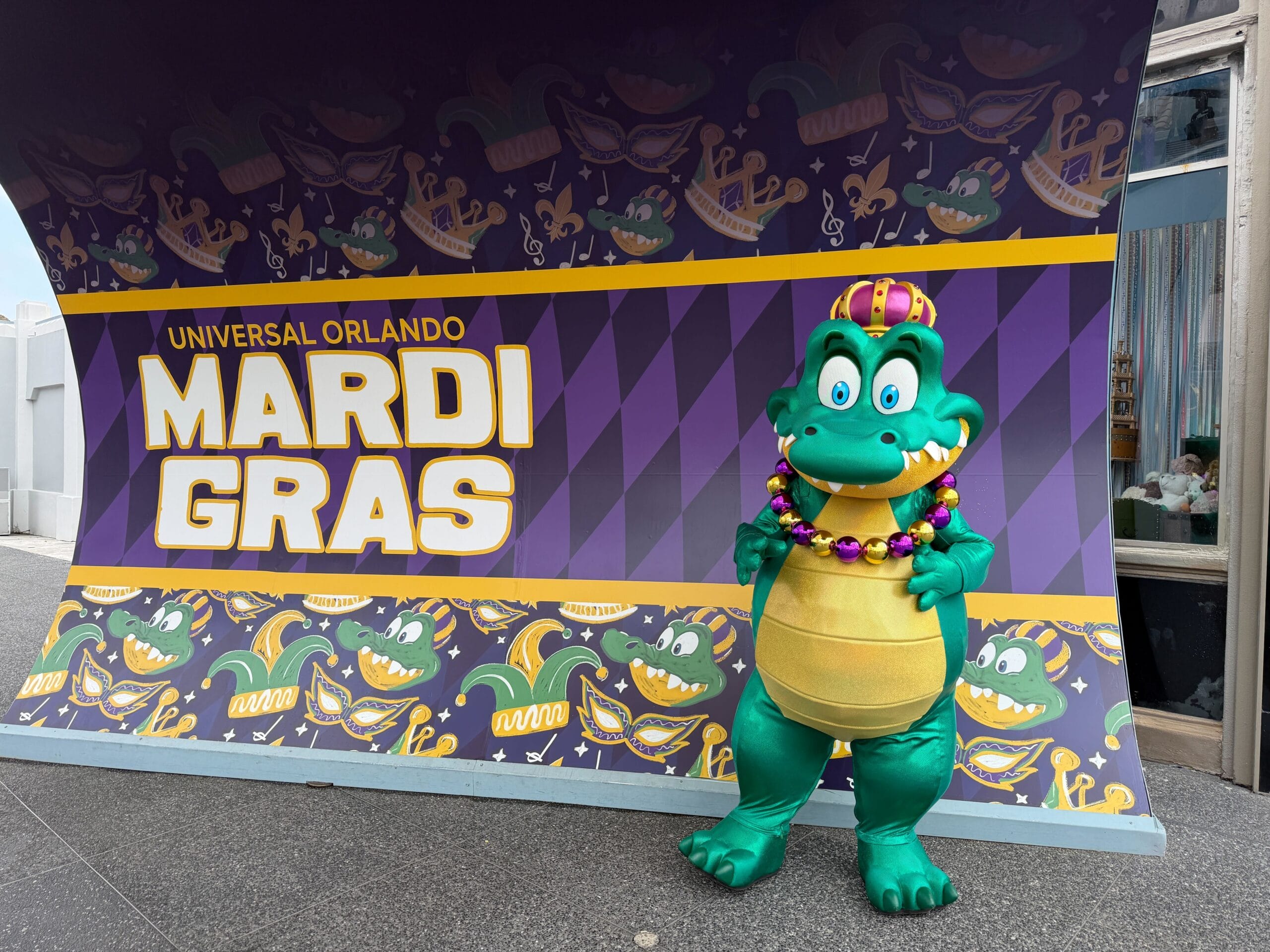 Prince Gator is the son of King Gator. King Gator is a fan-favorite float that closes out the nightly parade. The character has a necklace of gold and purple beads and a matching crown. He meets in font of a themed Mardi Gras banner with images of his face, crowns, and jester hats.