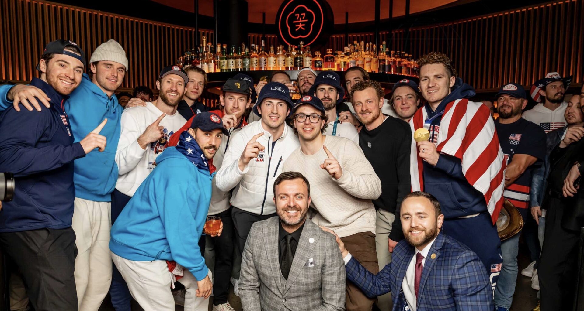 photo of the U.S. Men’s Hockey Team huddling for a photo inside a club