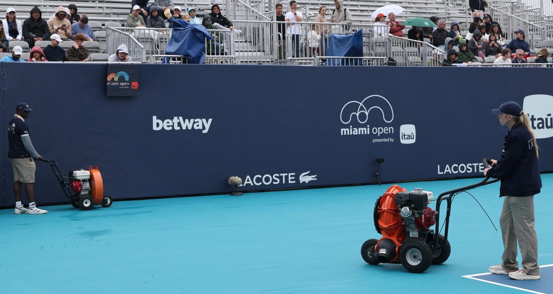 Mar 18, 2026; Miami Gardens, FL, USA; Workers dry Butch Buchholz Court during a rain delay on day 2 of the 2026 Miami Open at Hard Rock Stadium.