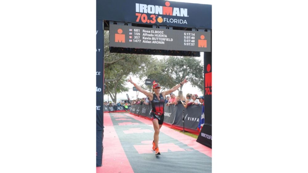 Rosa Laura Saggese Elbooz crosses the finish line at an Ironman 70.3 race in Florida