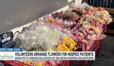 Volunteers arrange flowers for hospice patients