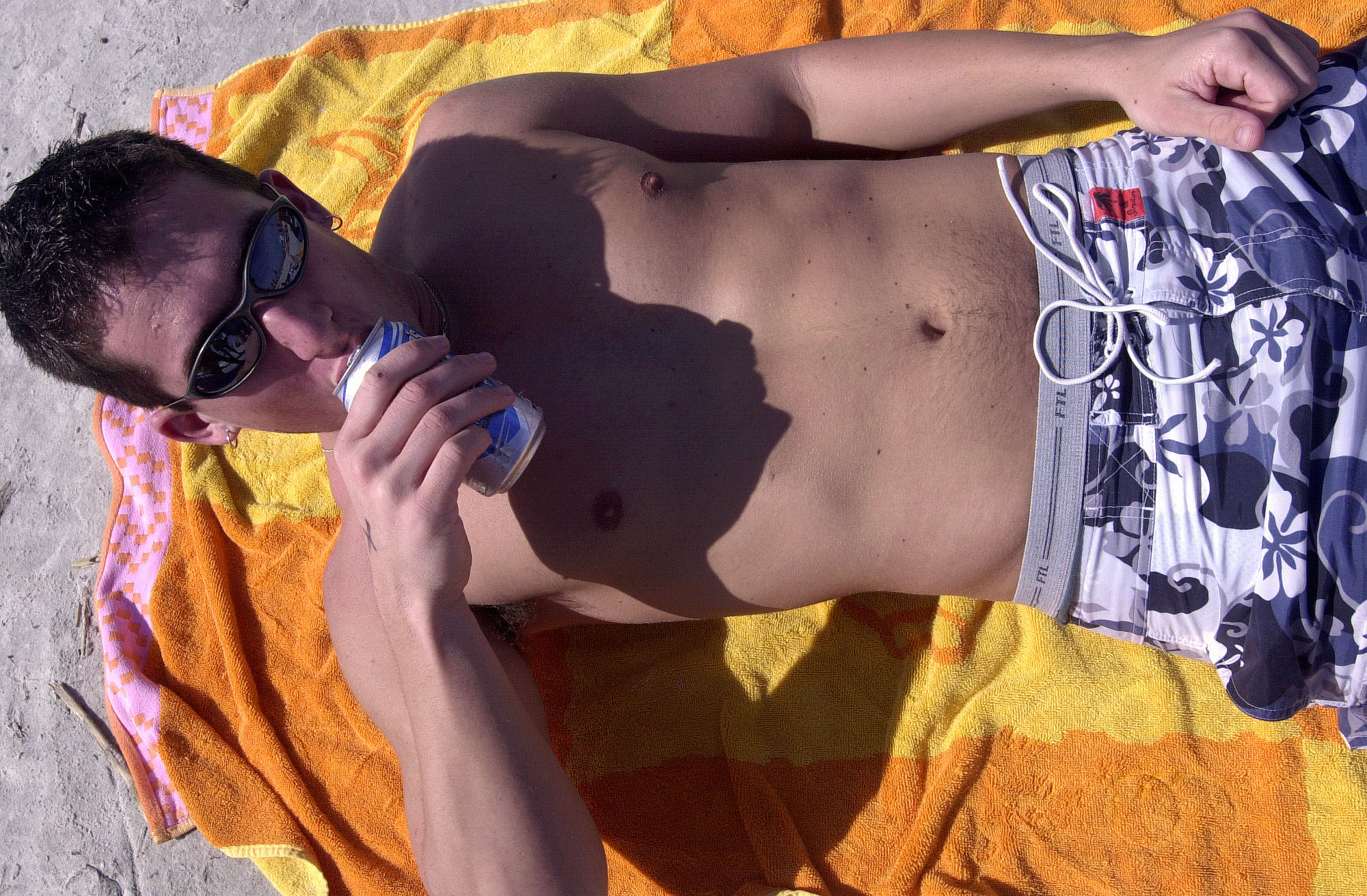 Spring Breakers chill out on at Daytona Beach with concealed...