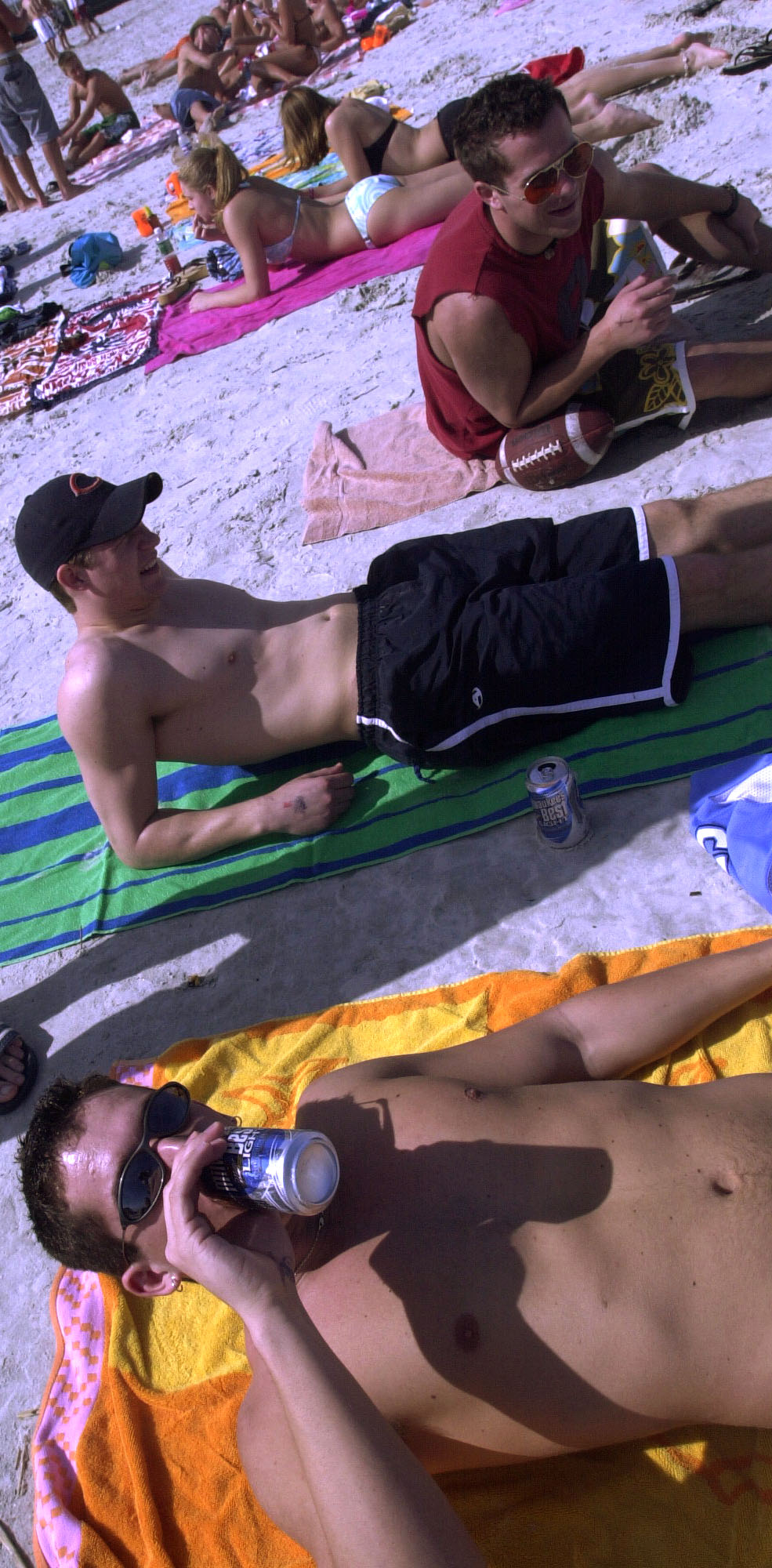 Spring Breakers chill out on at Daytona Beach with concealed...