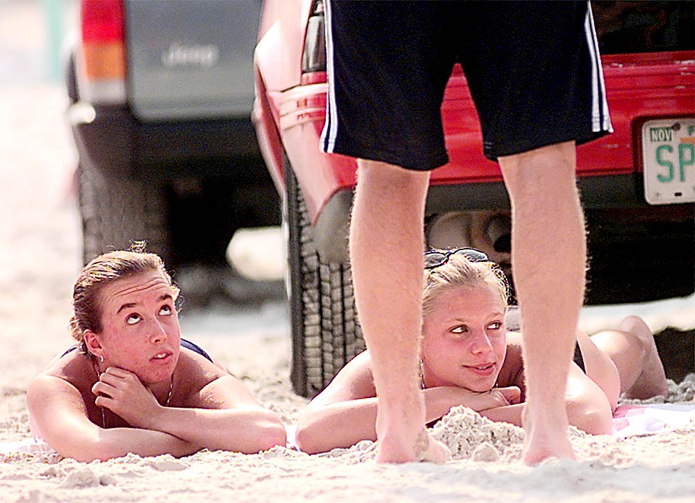 Megan Boda, right, and Aime Randero watch the happenings on...