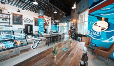 Interior of Foxtail Coffee Sarasota cafe with seating, espresso bar and mural artwork