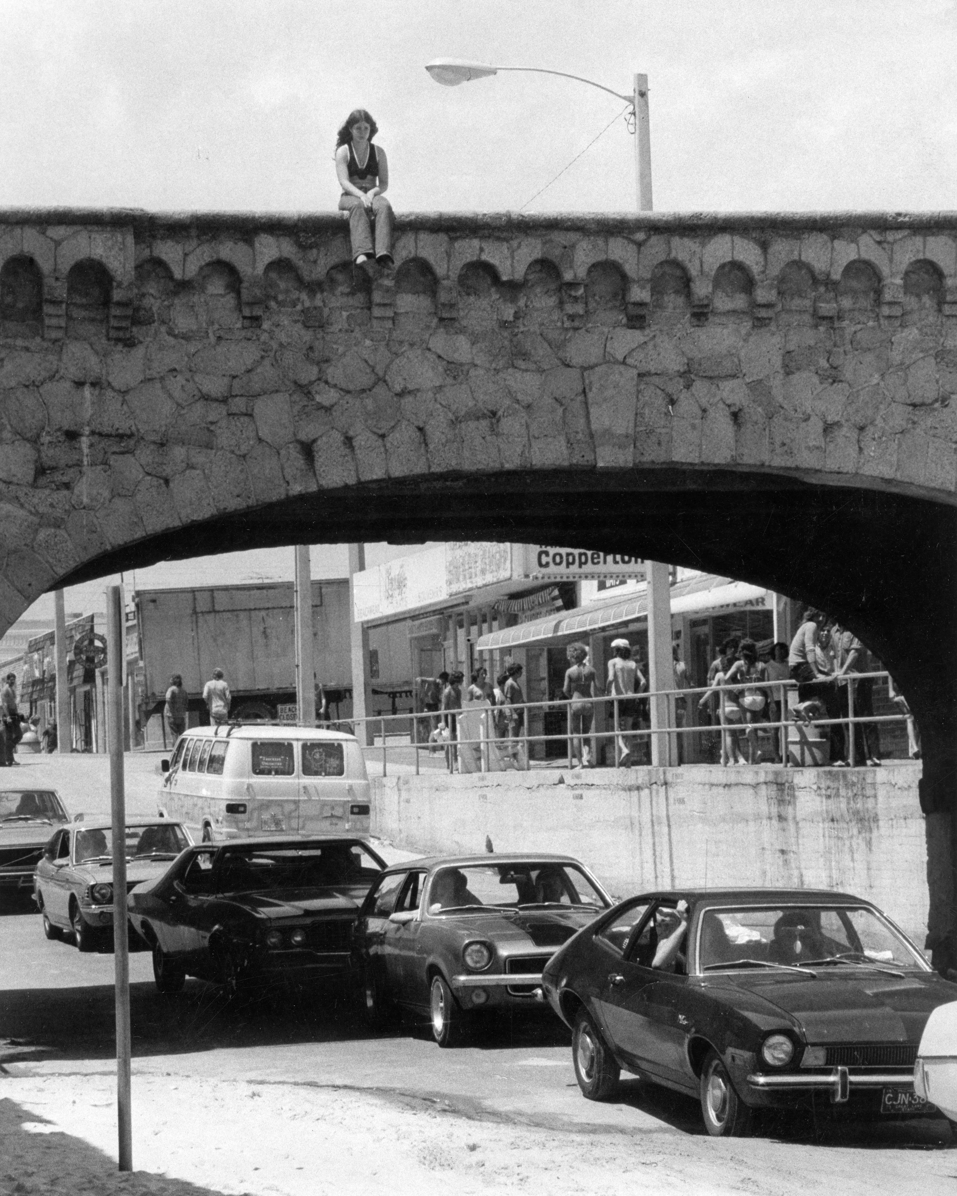 Rosemarie Green of Detriot sits on a bridge and watches...