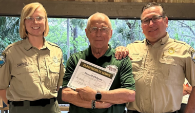 From left to right: Wekiwa Springs State Park service specialist Emily Campbell (left) and park manager Rene Acuna (right) pose with Don Philpott.