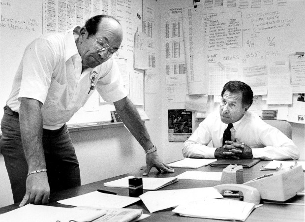 Renegades Coach Lee Corso (right) and executive Tommy Bland listen to the speaker telephone for news about other USFL teams' draft picks as Orlando worked to improve its team in May, 1986. ORG XMIT: OSC5Q1ORO54