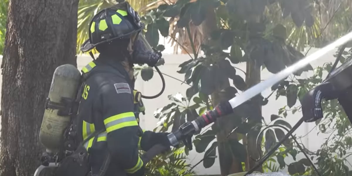 Police help resident escape burning duplex through window