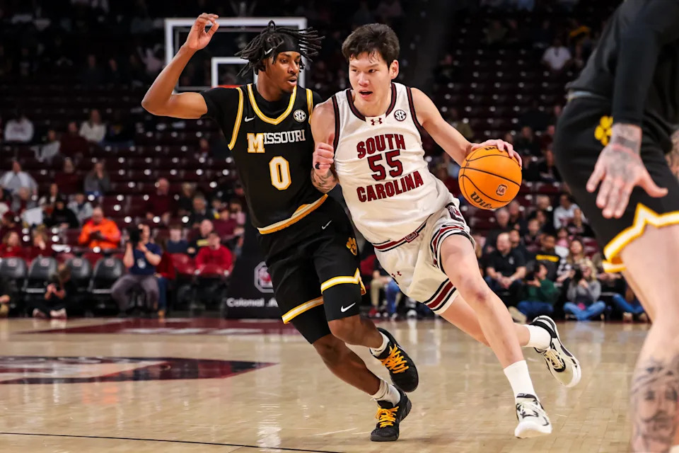 Feb 7, 2026; Columbia, South Carolina, USA; South Carolina Gamecocks guard Mike Sharavjamts (55) drives around Missouri Tigers guard Anthony Robinson II (0) in the first half at Colonial Life Arena. Mandatory Credit: Jeff Blake-Imagn Images