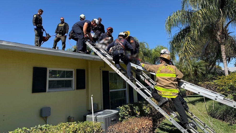 Firefighters guide the patient to the ground after completing a rooftop rescue in Jensen Beach on Feb. 24, 2026. Crews moved quickly to get him into the ambulance for further care. (Martin County Fire Rescue)