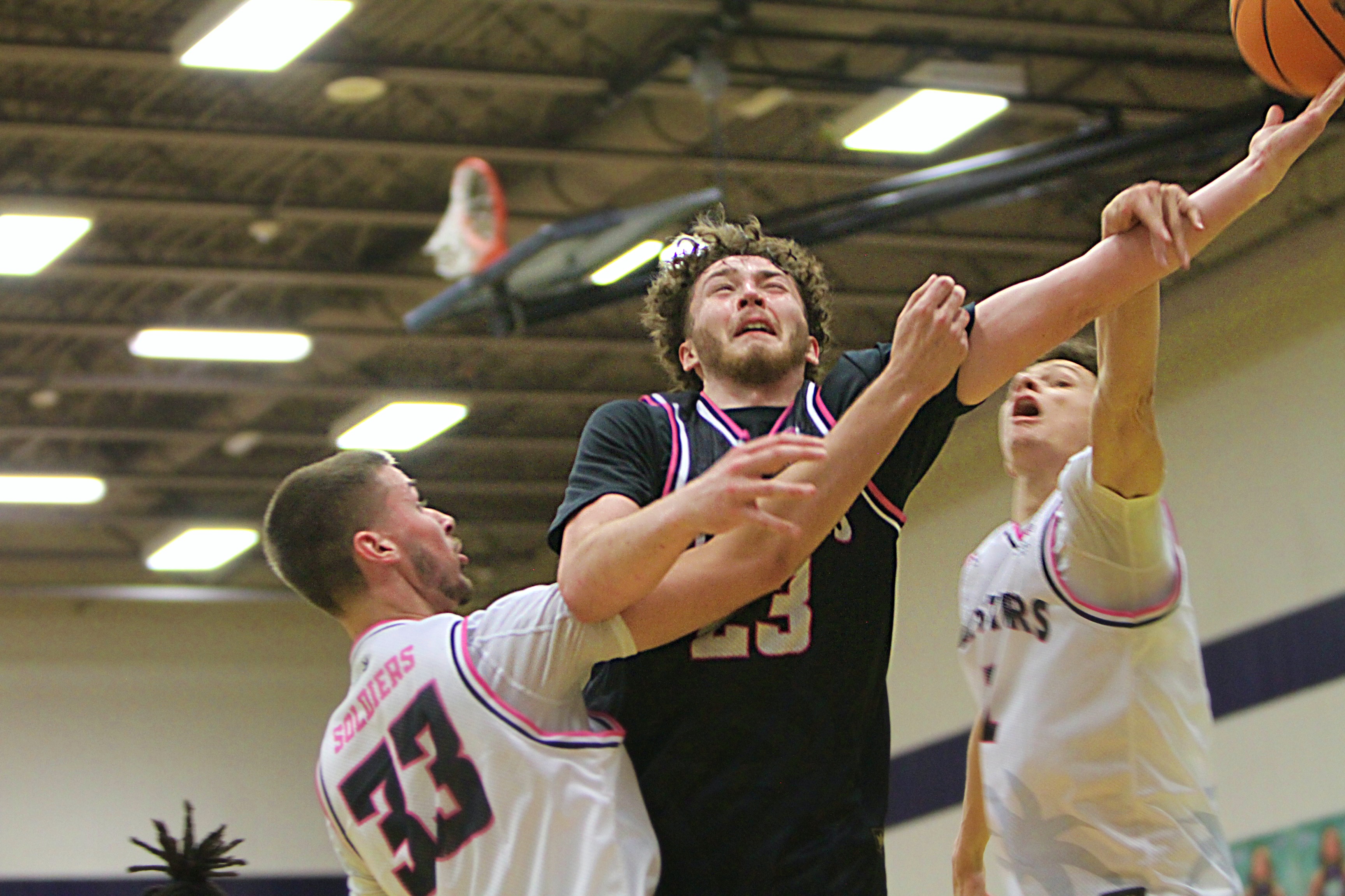 Alex Dipaolo of Central Florida Christian (23) split defenders Kyle...