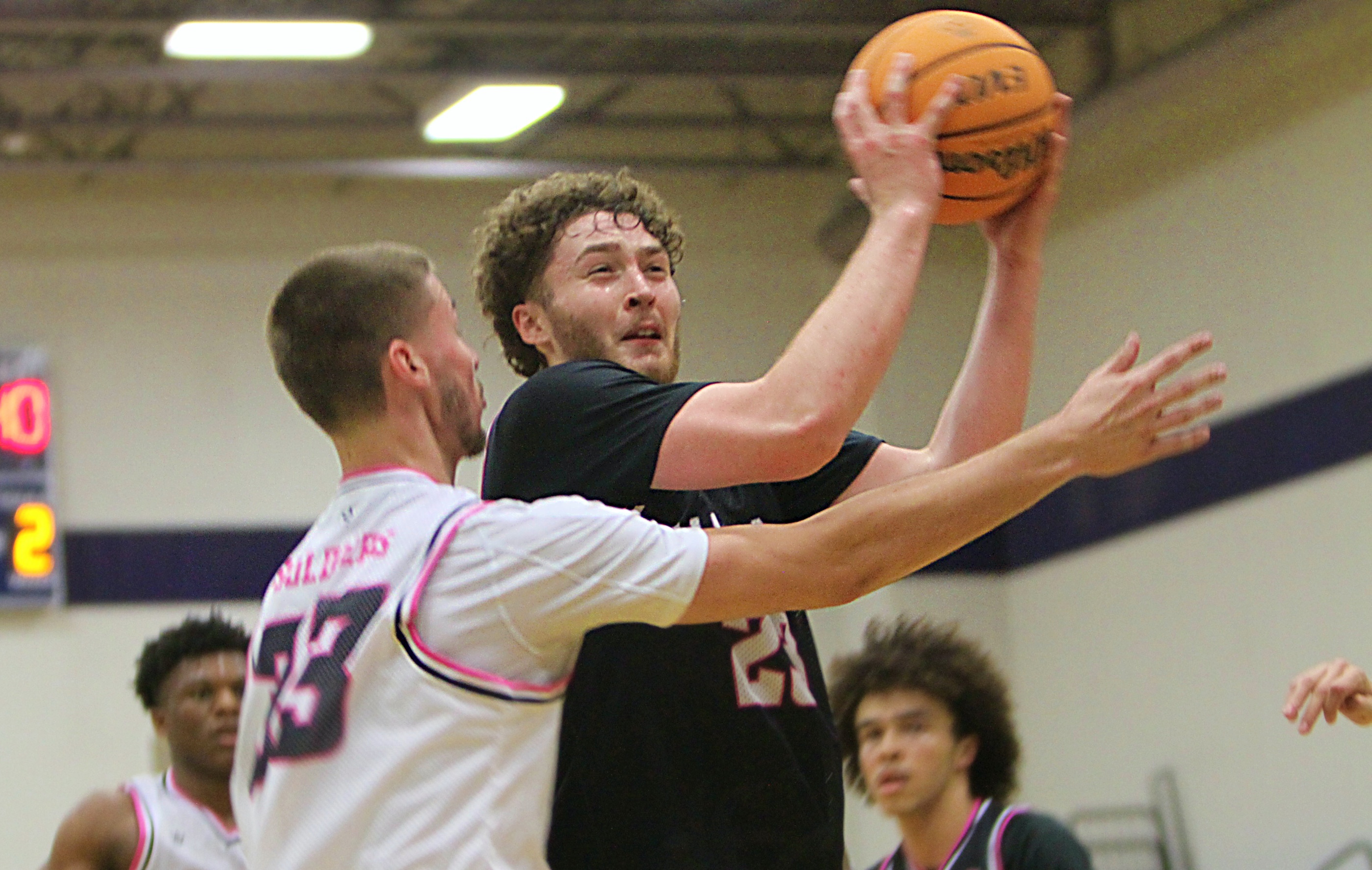 Kyle Bailey of Orlando University applies defensive pressure to Alex...
