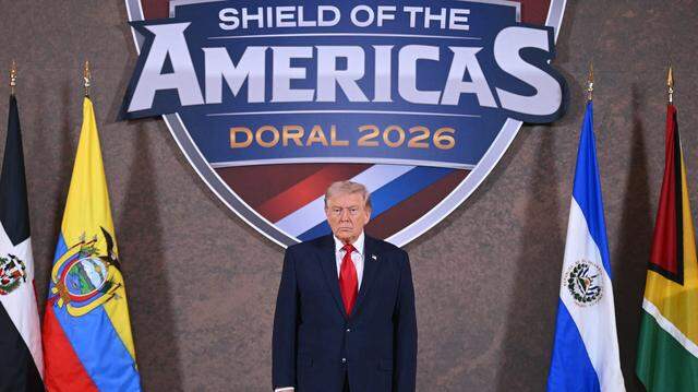 US President Donald Trump poses for a photo at the start of the "Shield of the Americas" Summit at Trump National Doral in Miami, Florida, March 7, 2026. President Trump is hosting a dozen right-wing leaders from Latin America and the Caribbean to discuss issues facing the region, from organized crime to illegal immigration. The summit also aims to serve Washington by boosting US interests in the region and curbing those from foreign powers like China. (Photo by SAUL LOEB / AFP via Getty Images)