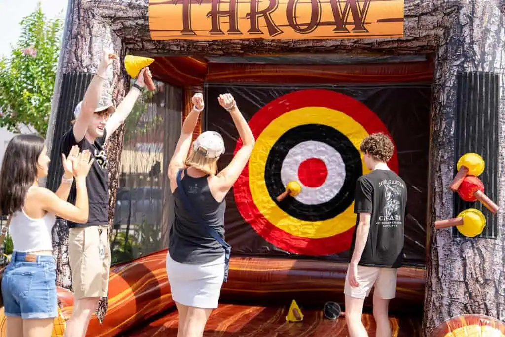 People playing an axe throwing game