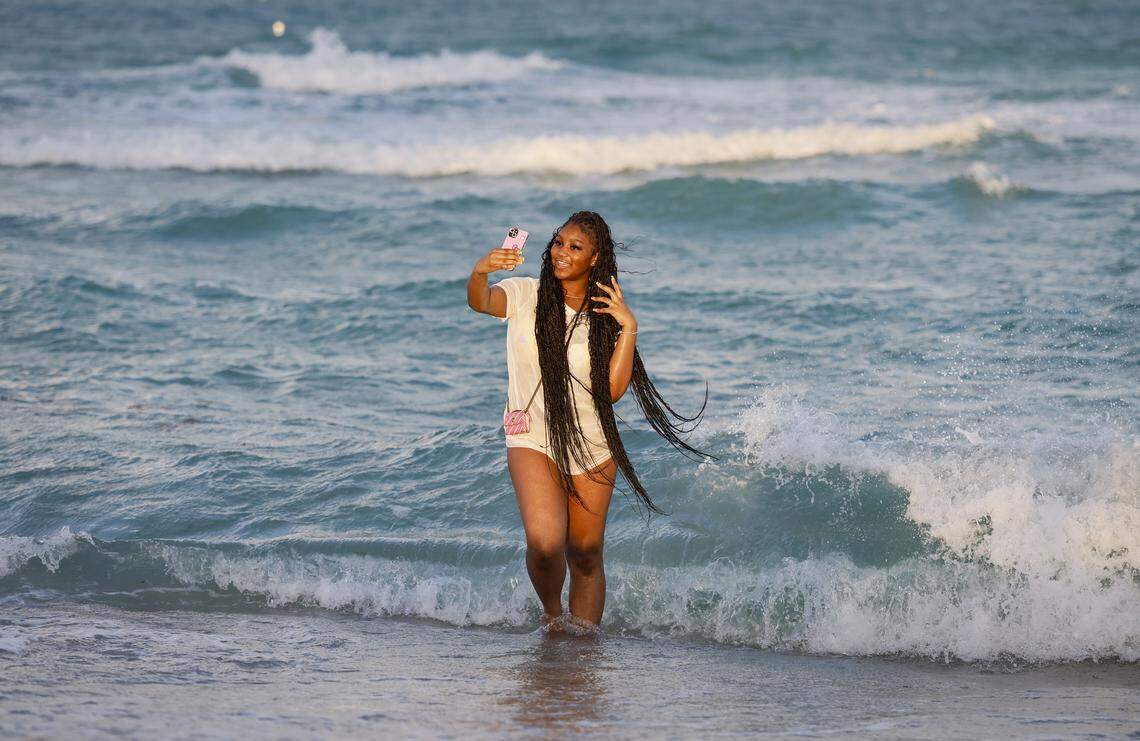 Lea Smith of South Carolina takes a selfie on the shore of South Beach during spring break in Miami Beach, Florida, on Friday, March 20, 2026.