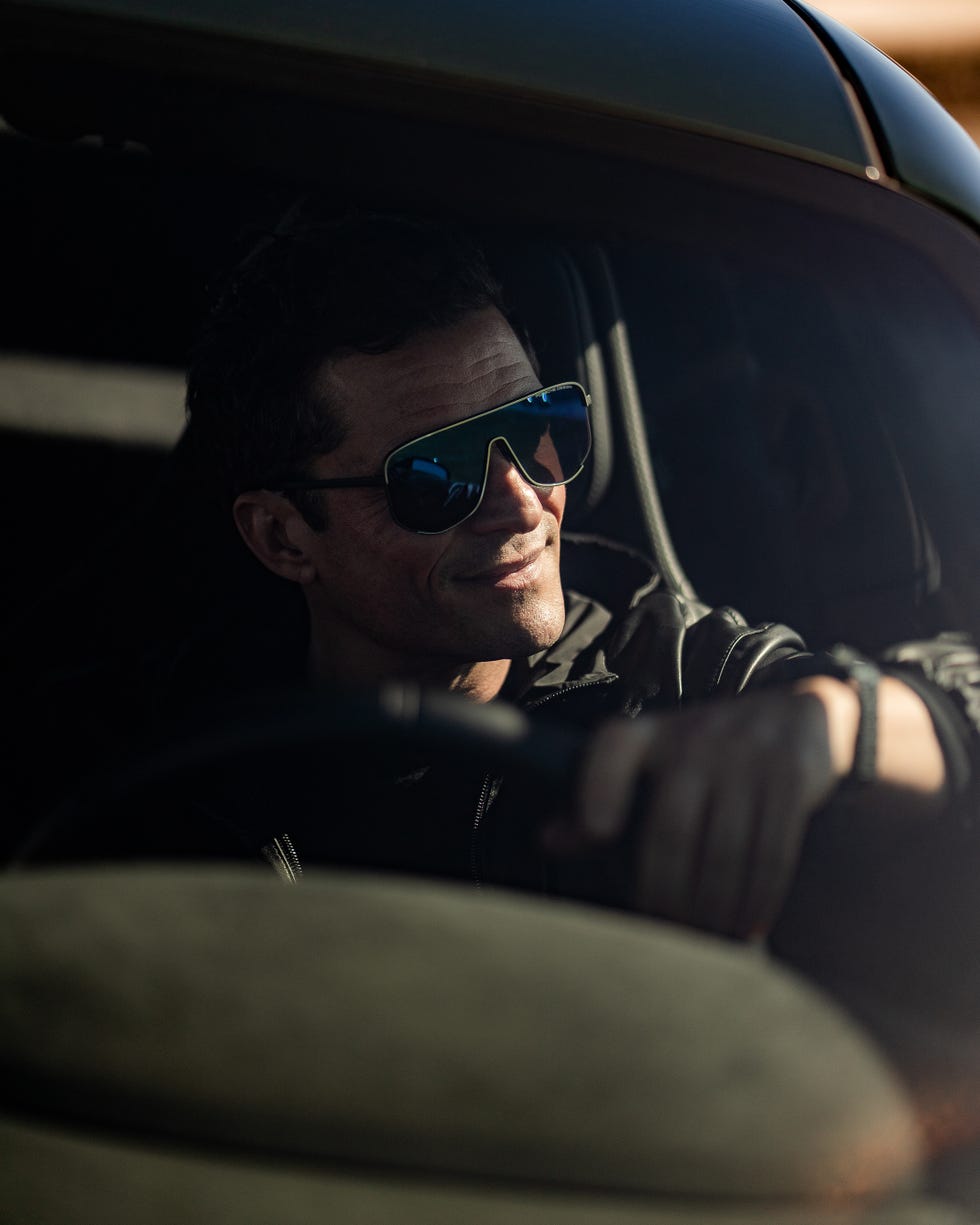 driver in a car with a focus on the hand on the steering wheel