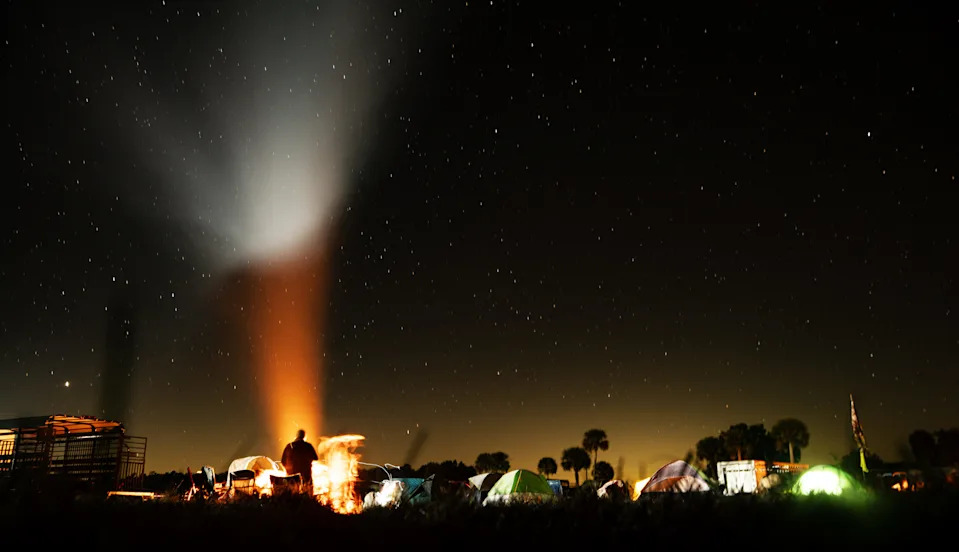 Participants and crew of the Great Florida Cattle Drive 2026 stay warm by fire under the stars on Thursday, Jan. 29, 2026 morning. Temperatures at night were in the 30’s and 40 throughout the reenactment.