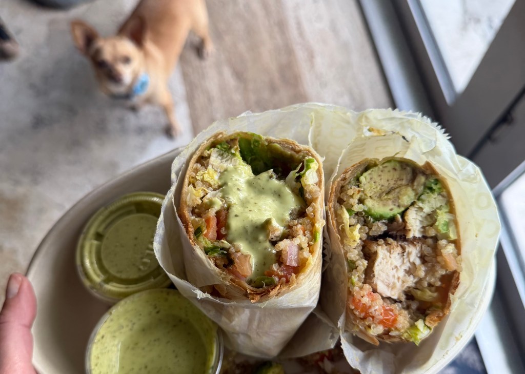 a sauced-covered fish wrap sliced in half to show the inside