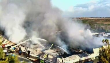 Miami-Dade warehouse fire continues to smolder 24 hours after blaze breaks out