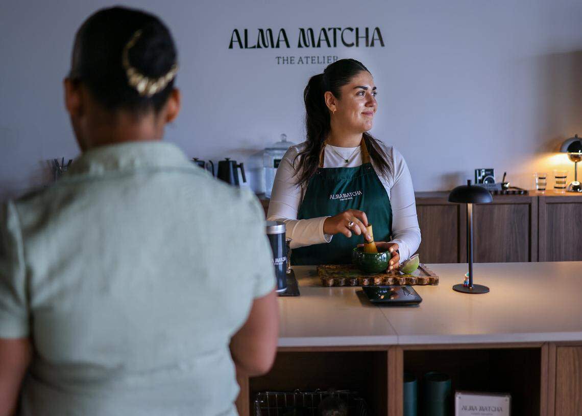 Maddison Haruch, right, prepares a matcha for a customer at Alma Matcha's temporary location as the buildout for its permanent store is underway at the Thrive Art District.