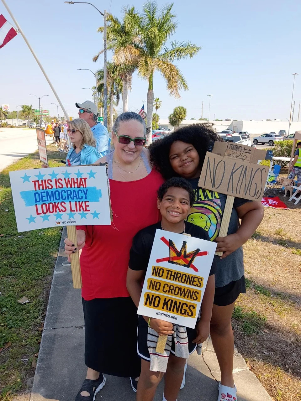 Meghan Martin with Micajah, 10, and Maggie Martin-Newman, 11, at the kids' first-ever protest at the Edison Mall in Fort Myers on March 28, 2026. "I'm glad there's a lot of people like this in our town," said Micajah.