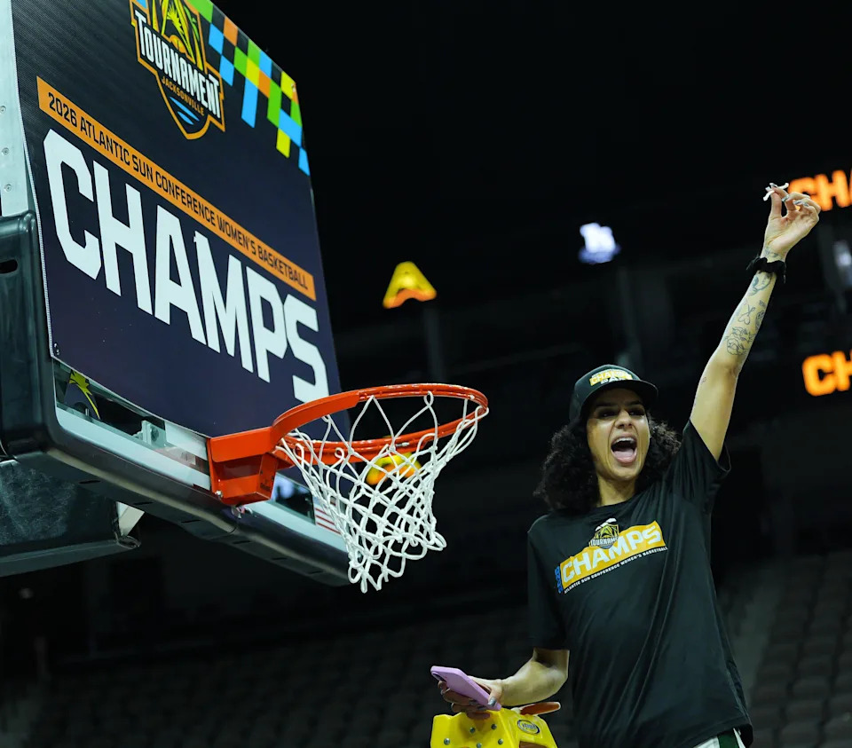 Jacksonville Dolphins guard Priscilla Williams (23) celebrates after cutting off a portion of the net after Jacksonville University defeated Austin Peay 66-63 in overtime in the ASUN Women's Basketball Tournament Championship at VyStar Veterans Memorial Arena Monday, March 9, 2026 in Jacksonville, Fla.[Doug Engle/Florida Times-Union]