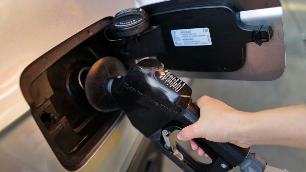 A person fills up her vehicle's gas tank at a gas station in Buffalo Grove, Ill., Thursday, March 19, 2026. (AP Photo/Nam Y. Huh)