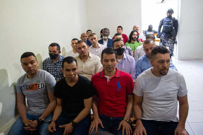 Colombian men, who are suspects and accused of involvement in the assassination of former Haitian President Jovenel Moise, sit in handcuffs during a hearing at the Court of Appeals in Port-au-Prince, Haiti, on January 27, 2025. Moise was murdered in July 2021. (Photo by Clarens SIFFROY / AFP) (Photo by CLARENS SIFFROY/AFP via Getty Images)