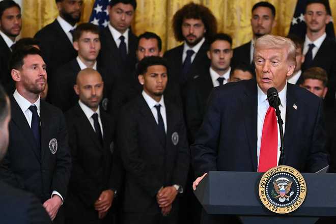 US President Donald Trump as Argentinian star Lionel Mess (L) and coach Javier Mascherano (2nd L) look onduring an event for Inter Miami CF, winners of the 2025 Major League Soccer Cup, in the East Room of the White House in Washington, DC, on March 5, 2026. (Photo by ANDREW CABALLERO-REYNOLDS / AFP via Getty Images)