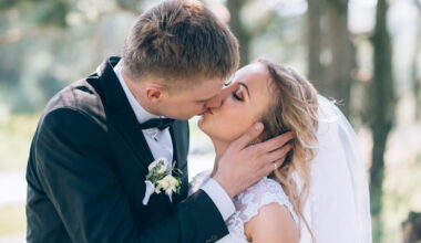 groom and bride kissing at wedding
