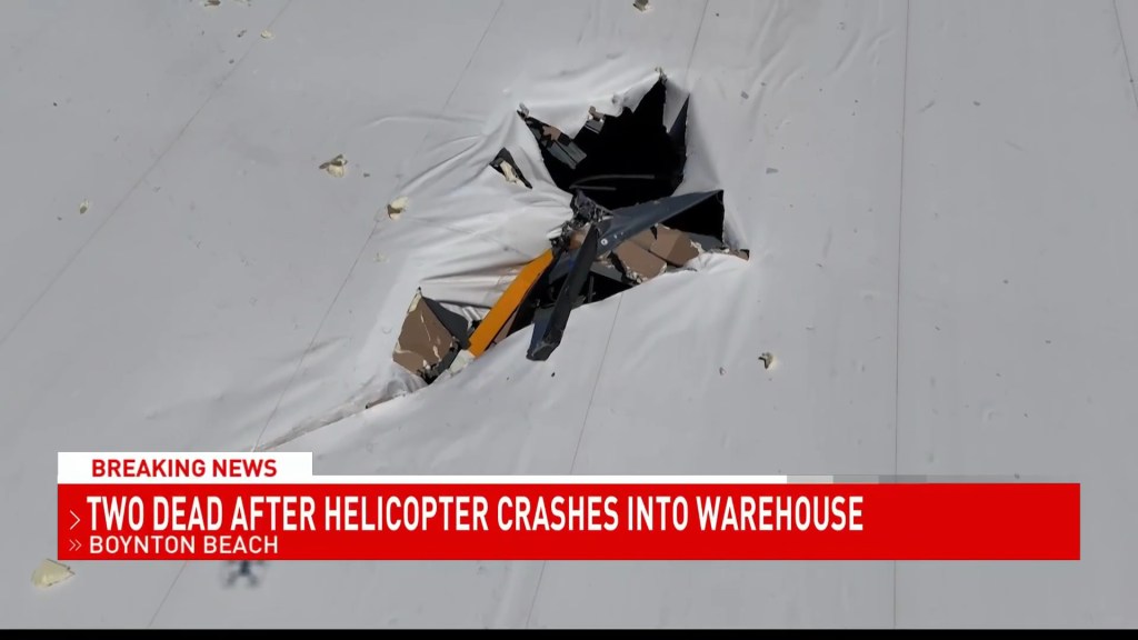 Helicopter wreckage after crashing through the roof of a warehouse.