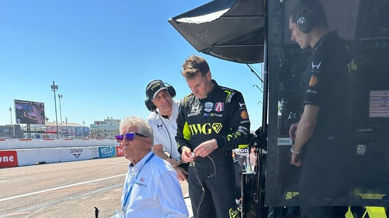 Will Power watches the IndyCar race on pit lane after...