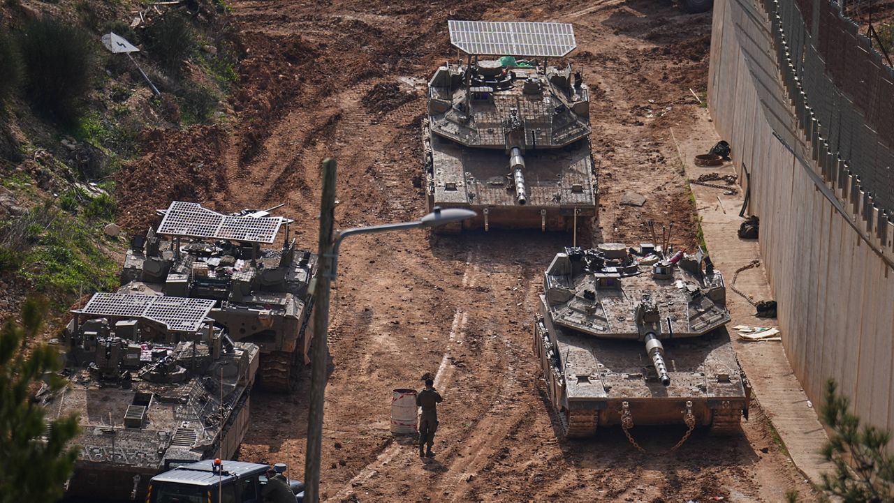 Israeli tanks maneuver near the Israel-Lebanon border, in northern Israel, Wednesday, March 4, 2026. (AP Photo/Ariel Schalit)