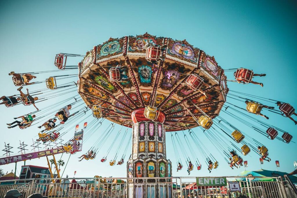 Photograph of people riding swing carousel