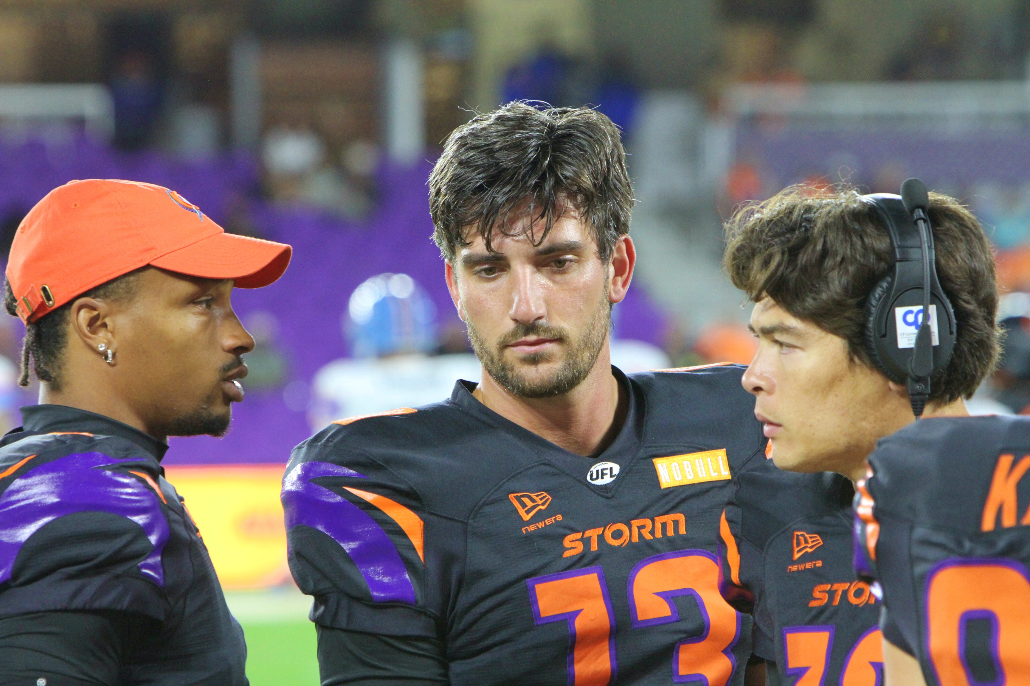 Orlando Storm quarterback Jack Plummer (13) confers with back-up quarterbacks...