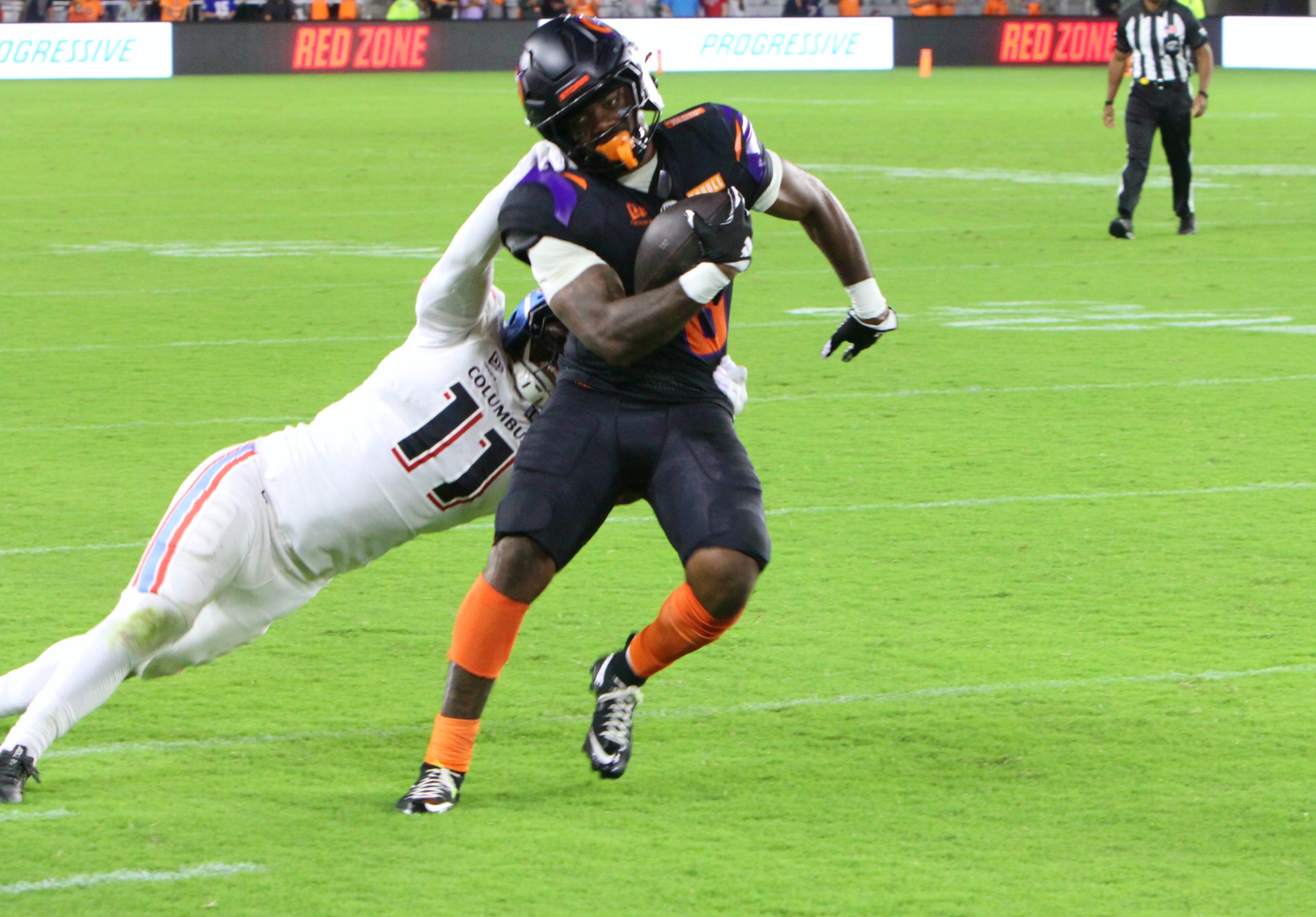Orlando Storm running back Jashaun Corbin is tackled by Columbus...