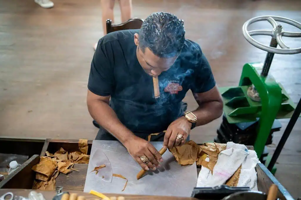 A person rolling a cigar