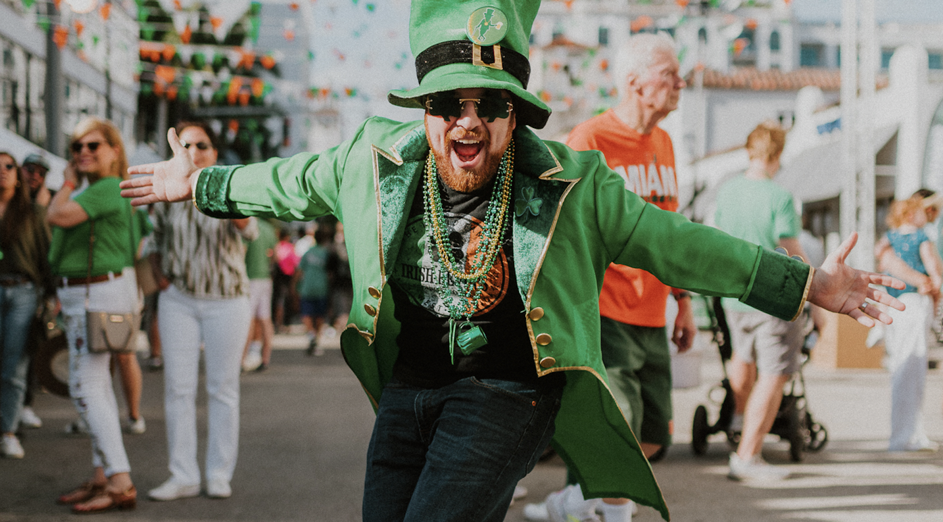 a man in all green wearing a leprechaun outfit at a St. Patrick's Day festival