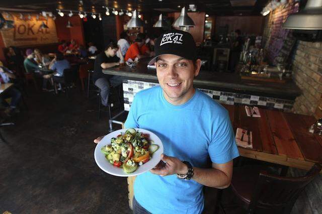 LoKal owner Matt Kuscher in 2012 at the neighborhood restaurant, just a year after it opened in Commodore Plaza in Coconut Grove.